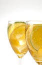 Two stemmed glasses with ice tea and lemon and lime