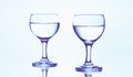 Two stemmed glasses of water