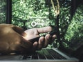 Two steps authentication concept. Virtual key icon on smartphone while using laptop for validate password.