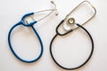 two stethoscopes in rounded shape one blue and one black Royalty Free Stock Photo