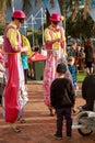 Two stilt walkers entertaining children