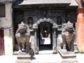 Two stone lions at the entrance gate of Hiranya Varna Mahavihar. Golden temple. Patan, Kathmandu. Nepal