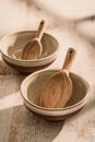 Two stoneware bowls with wooden spoon on kitchen table Royalty Free Stock Photo