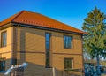 Two-storey house with long narrow vertical window on the stairwell, outside Royalty Free Stock Photo