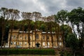 Two-storey old house on the background of trees and cars Royalty Free Stock Photo