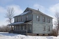 Two-storey, wooden house in a snow-covered field Royalty Free Stock Photo