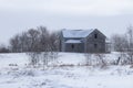 Two-storey, wooden house in a snow-covered field Royalty Free Stock Photo