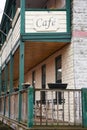 Cafe facade sign on upper story of outdoor porch advertises food and beverages Royalty Free Stock Photo