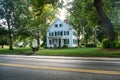 Two-story house in a traditional American style covered with siding