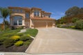 Two Story Mediterranean Home With A Tile Roof and a Palm Tree Royalty Free Stock Photo