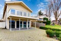 Two story paneled house with glass balcony