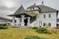 a two-story white monastery building with a wooden roof Royalty Free Stock Photo