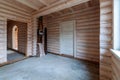 A two-story wooden cottage from the inside out in coniferous spruce pine green forest. Amazing heartbreaking view from the Royalty Free Stock Photo