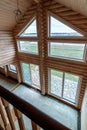 A two-story wooden cottage from the inside out in coniferous spruce pine green forest. Amazing heartbreaking view from the