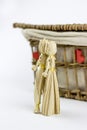 Two straw dolls in front of an old casket Royalty Free Stock Photo
