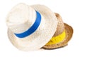 Two straw hat with a blue yellow ribbon isolated on white background Royalty Free Stock Photo