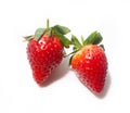 Two strawberries lie next to each other in close-up, isolated on a white background Royalty Free Stock Photo