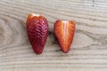 Two strawberries, one strawberry cut in half Royalty Free Stock Photo