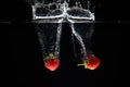 Two strawberrys splashing into water Royalty Free Stock Photo