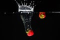 Two strawberrys splashing into water Royalty Free Stock Photo