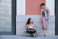 Two street musicians looking each other and laughing, playing instruments. Royalty Free Stock Photo