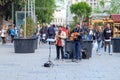 Two street musicians playing beautiful lyrical music and creating unique relaxing atmosphere for walking tourists in square in the Royalty Free Stock Photo