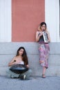 Two street musicians playing handpand and melodica blow organ at street. Royalty Free Stock Photo