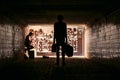 Two street musicians in the underpass. Silhouette photo. Vagrant lifestyle. Playing to make money a living. Unemployed musician.