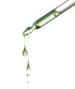 Two stretched oily drops falls from a pipette close-up isolated on a white background Royalty Free Stock Photo