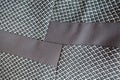 Two strips of brown fabric sewn to grey one