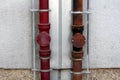 Two strong rusted metal gutter rainfall pipes connected to lightning rod on both sides mounted on side of local apartment building