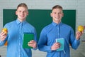 Two student holding books and smiling at camera. Learning and education concept. Group of high school students in Royalty Free Stock Photo