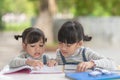 Two student little Asian girls reading the book on table Royalty Free Stock Photo