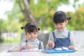 Two student little Asian girls reading the book on table Royalty Free Stock Photo