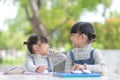 Two student little Asian girls reading the book on table Royalty Free Stock Photo