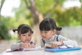 Two student little Asian girls reading the book on table Royalty Free Stock Photo