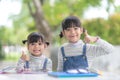 Two student little Asian girls reading the book on table Royalty Free Stock Photo