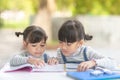 Two student little Asian girls reading the book on table Royalty Free Stock Photo