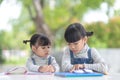 Two student little Asian girls reading the book on table Royalty Free Stock Photo