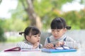 Two student little Asian girls reading the book on table Royalty Free Stock Photo