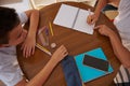 Two students collaborating on a homework project at a round table Royalty Free Stock Photo