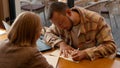 Two students focused on documents and making notes together in a cafe Royalty Free Stock Photo