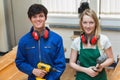 Two students holding a driller and a hammer Royalty Free Stock Photo