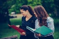Two students learning reading a notebook and commenting in the street Royalty Free Stock Photo