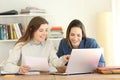 Two students learning together on line Royalty Free Stock Photo