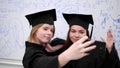 Two students make photo on phone in university. Royalty Free Stock Photo