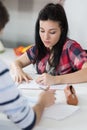 Two students male and female doing homework together