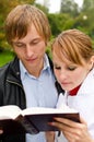 Two students reading a book Royalty Free Stock Photo