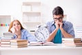 The two students runnng out of time to prepare for exams Royalty Free Stock Photo