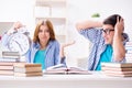 The two students runnng out of time to prepare for exams Royalty Free Stock Photo